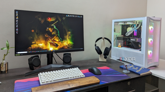 Desktop PC setup showing a gaming PC, monitor, keyboard, mouse, and headset