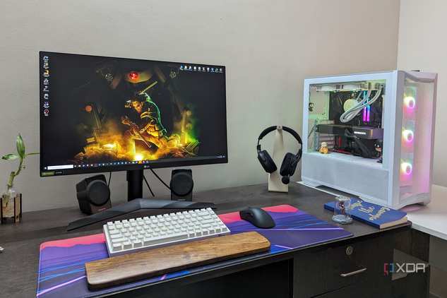 Desktop PC setup showing a gaming PC, monitor, keyboard, mouse, and headset