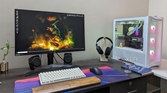 Desktop PC setup showing a gaming PC, monitor, keyboard, mouse, and headset