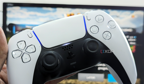 An image showing the DualSense controller with a gaming monitor in the background.