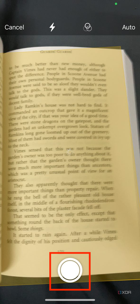 A screenshot captured on an iPhone showing the highlighted shutter button while scanning a document in iOS notes app