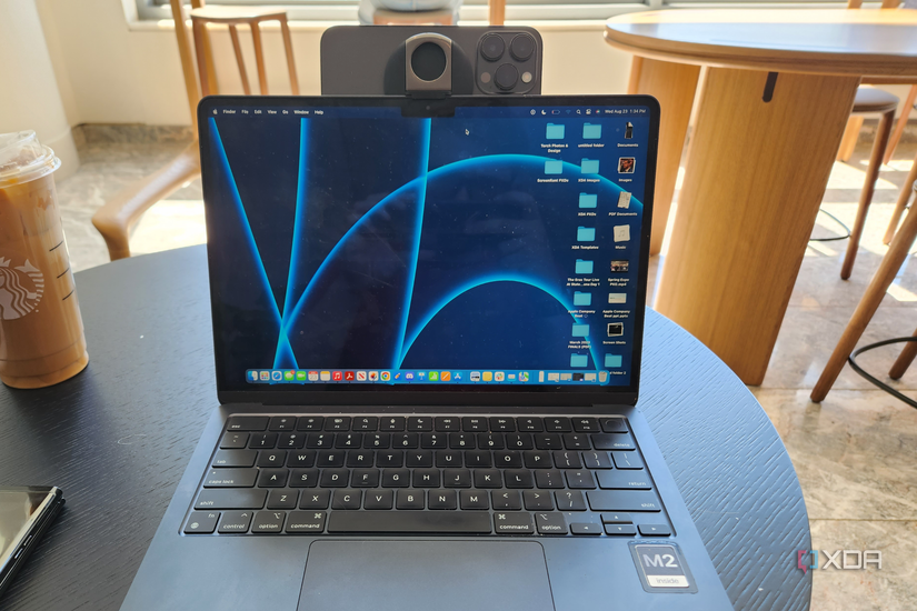 An iPhone mounted to a MacBook with Belkin's accessory.