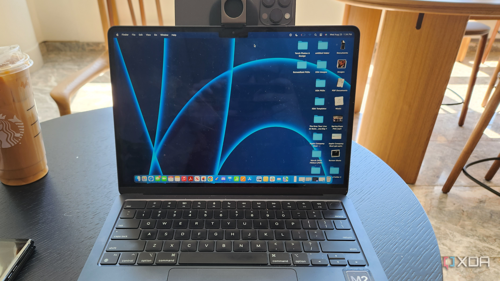 An iPhone mounted to a MacBook with Belkin's accessory.