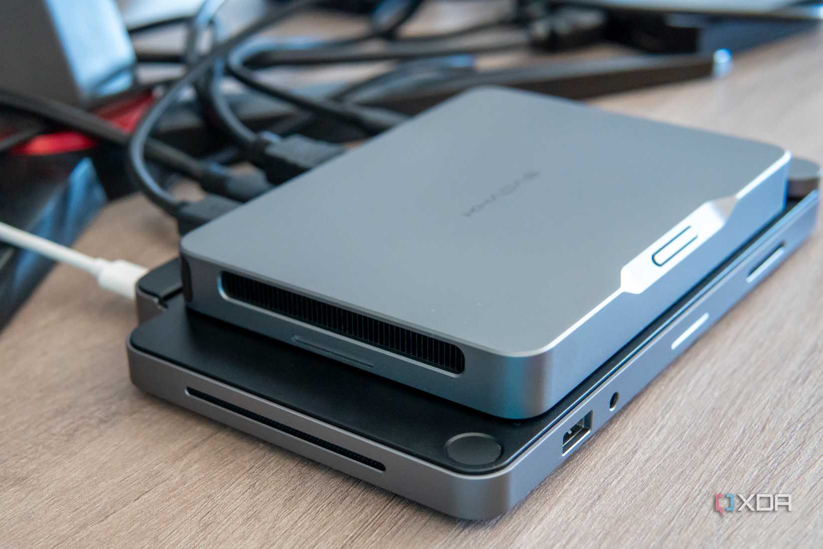 Left-side angled view of the Khadas Mind mounted on the Mind Dock, showing the speaker grill on the latter