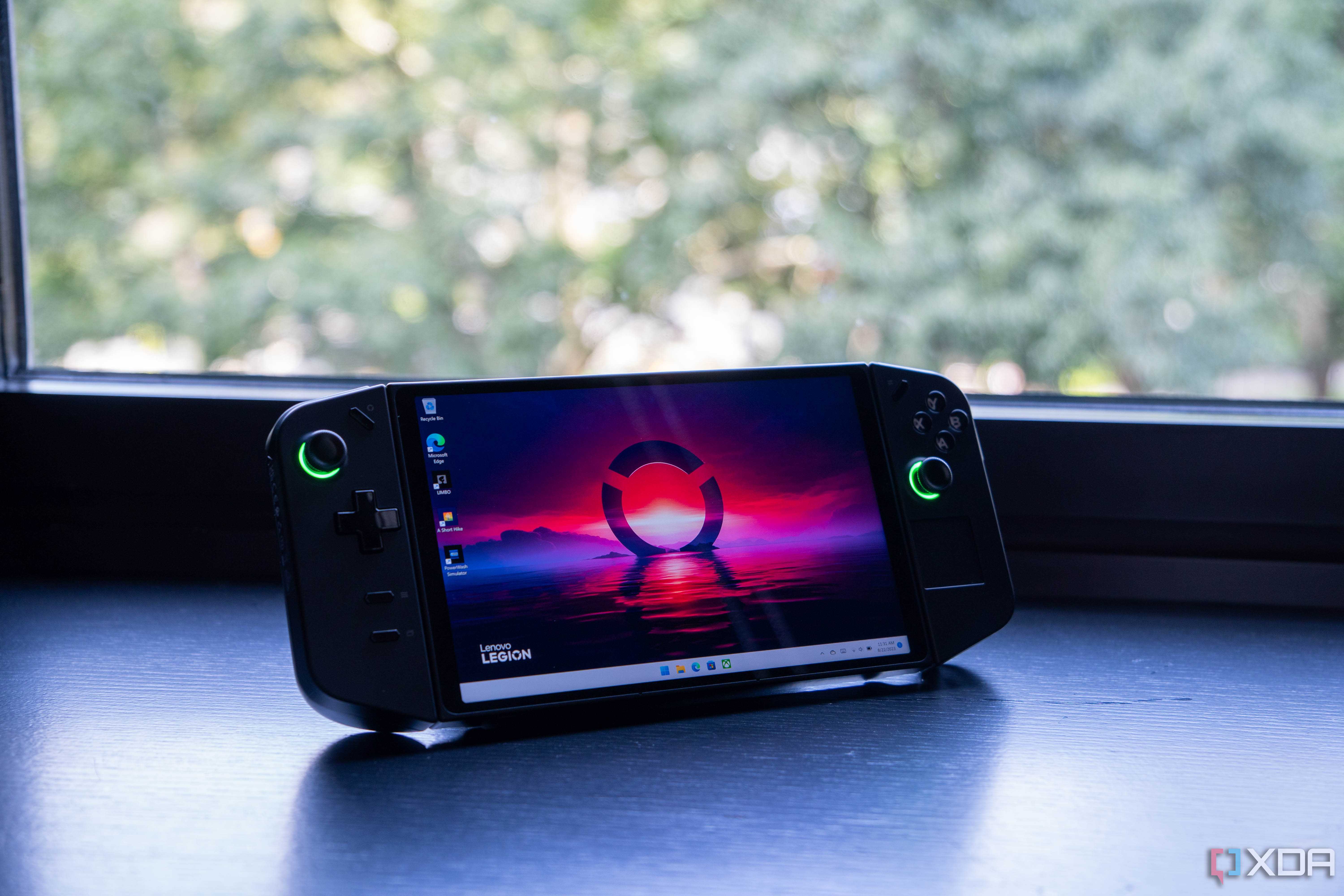 The Lenovo Legion Go sitting on a desk in front of a window