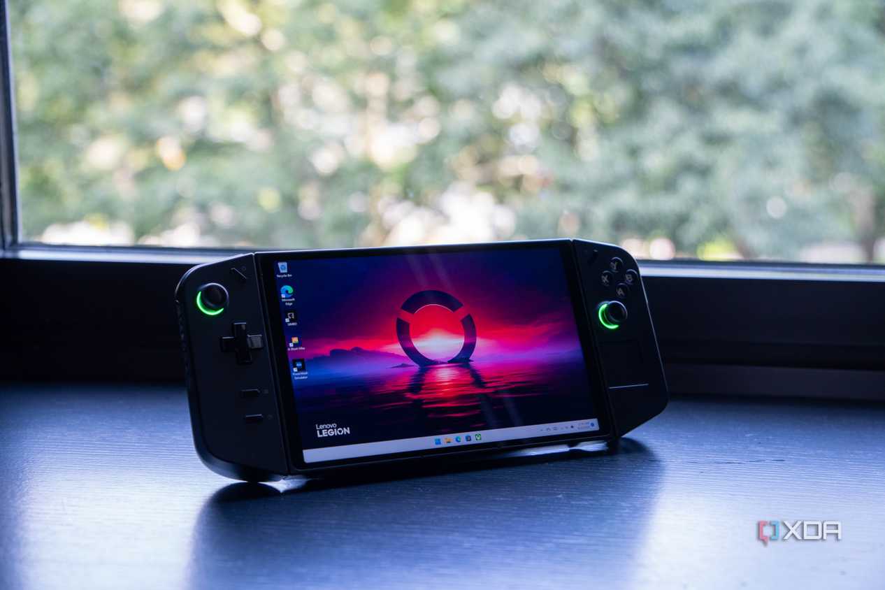 The Lenovo Legion Go sitting on a desk in front of a window