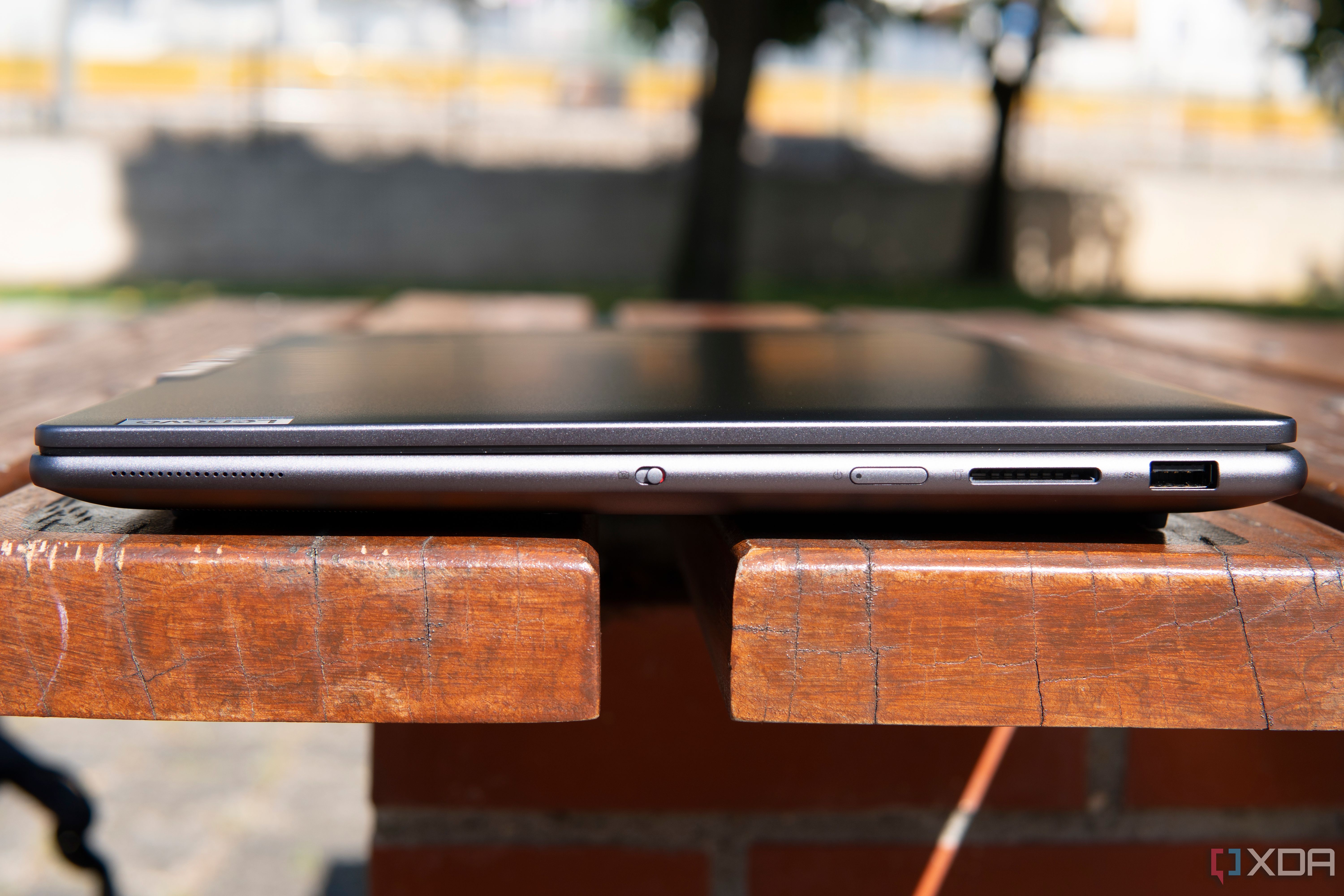 Right-side view of the Lenovo Slim Pro 9i 16-inch model with a USB Type-A port, SD card reader, power button, and a webcam kill switch