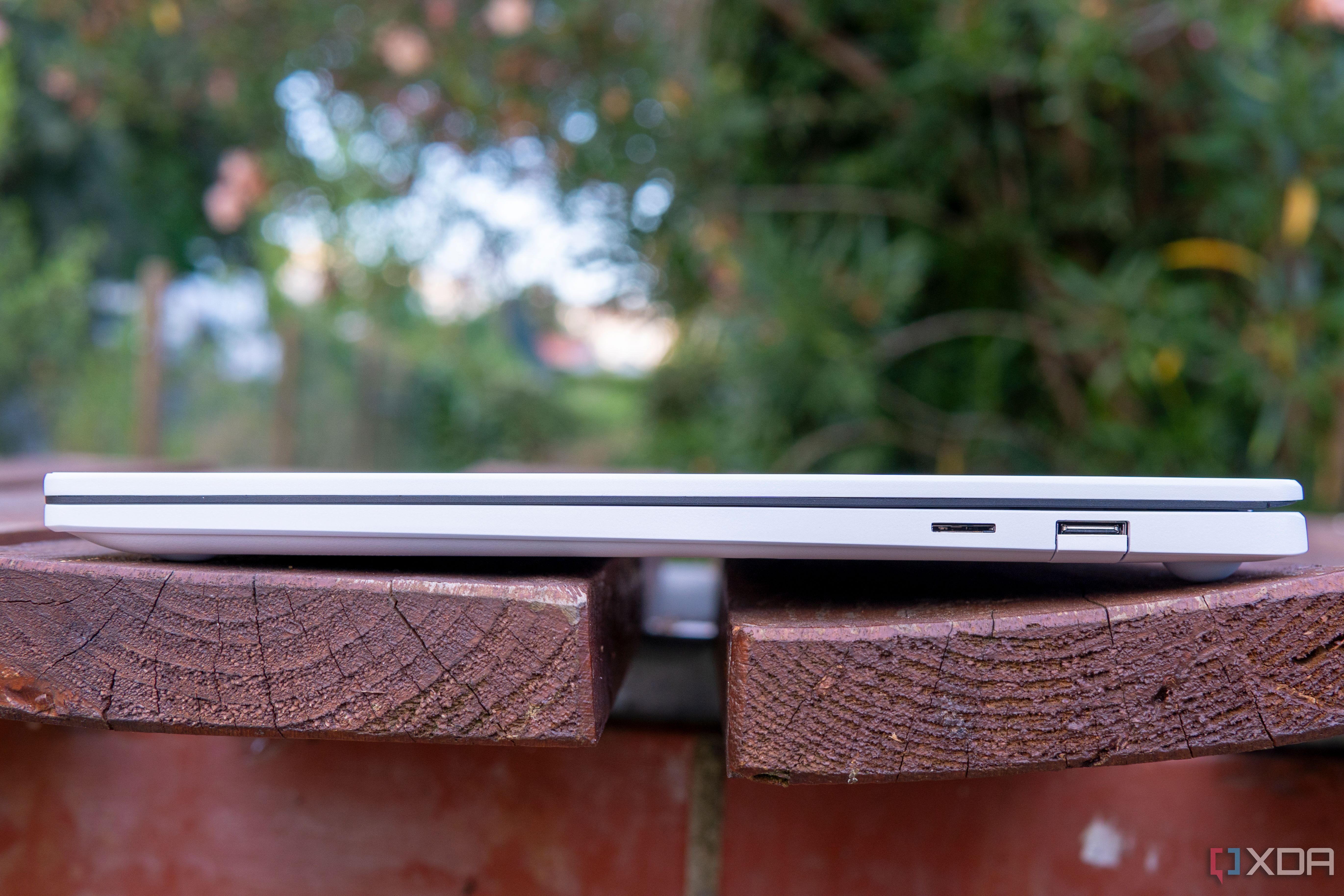Right-side view of the LG Gram Style with the lid closed showing a collpasible USB Type-A port and a microSD card slot