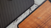 An image showing two Mous Limitless 5.0 case, one with Walnut and the other with Aramid finish on the back.