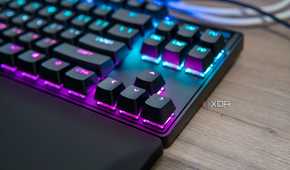 Close-up view of the arrow keys on a SteelSeries Apex Pro TKL keyboard with RGB lighting enables in pink and blue