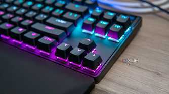 Close-up view of the arrow keys on a SteelSeries Apex Pro TKL keyboard with RGB lighting enables in pink and blue