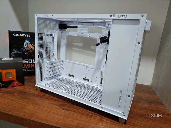 An image showing a disassembled Asus Prime AP201 case kept on a wooden table.