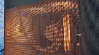 An image showing a white PC case with RGB-enabled components inside that can be seen through the mesh pattern.