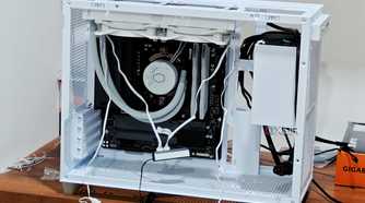 An image showing a half-built PC featuring the Asus Prime AP201 case in white color.