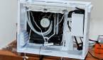 An image showing a half-built PC featuring the Asus Prime AP201 case in white color.