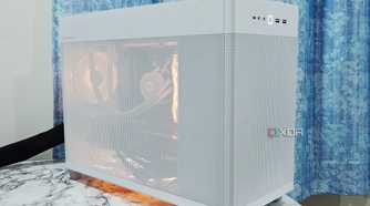 An image showing a white-colored Asus Prime AP201 PC case over a white marble surface.