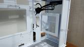 An image showing the front panel of a white-colored Asus Prime AP201 case.