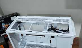An image showing the top panel of a white-colored Asus Prime AP201 case.