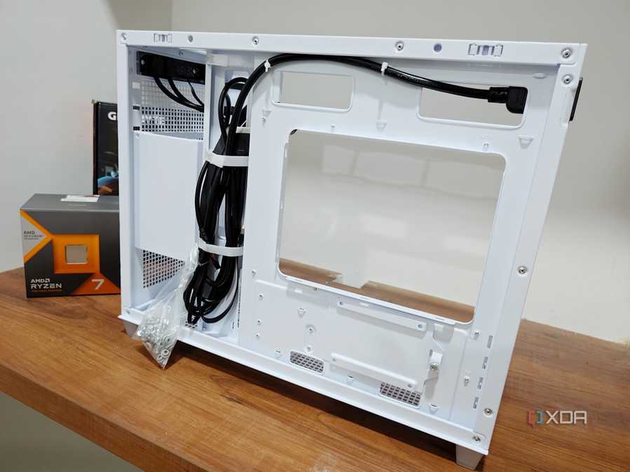 An image showing the motherboard side panel of a white-colored Asus Prime AP201 case.