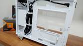 An image showing the motherboard side panel of a white-colored Asus Prime AP201 case.