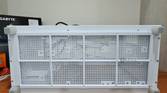 An image showing the bottom panel of a white-colored Asus Prime AP201 case.