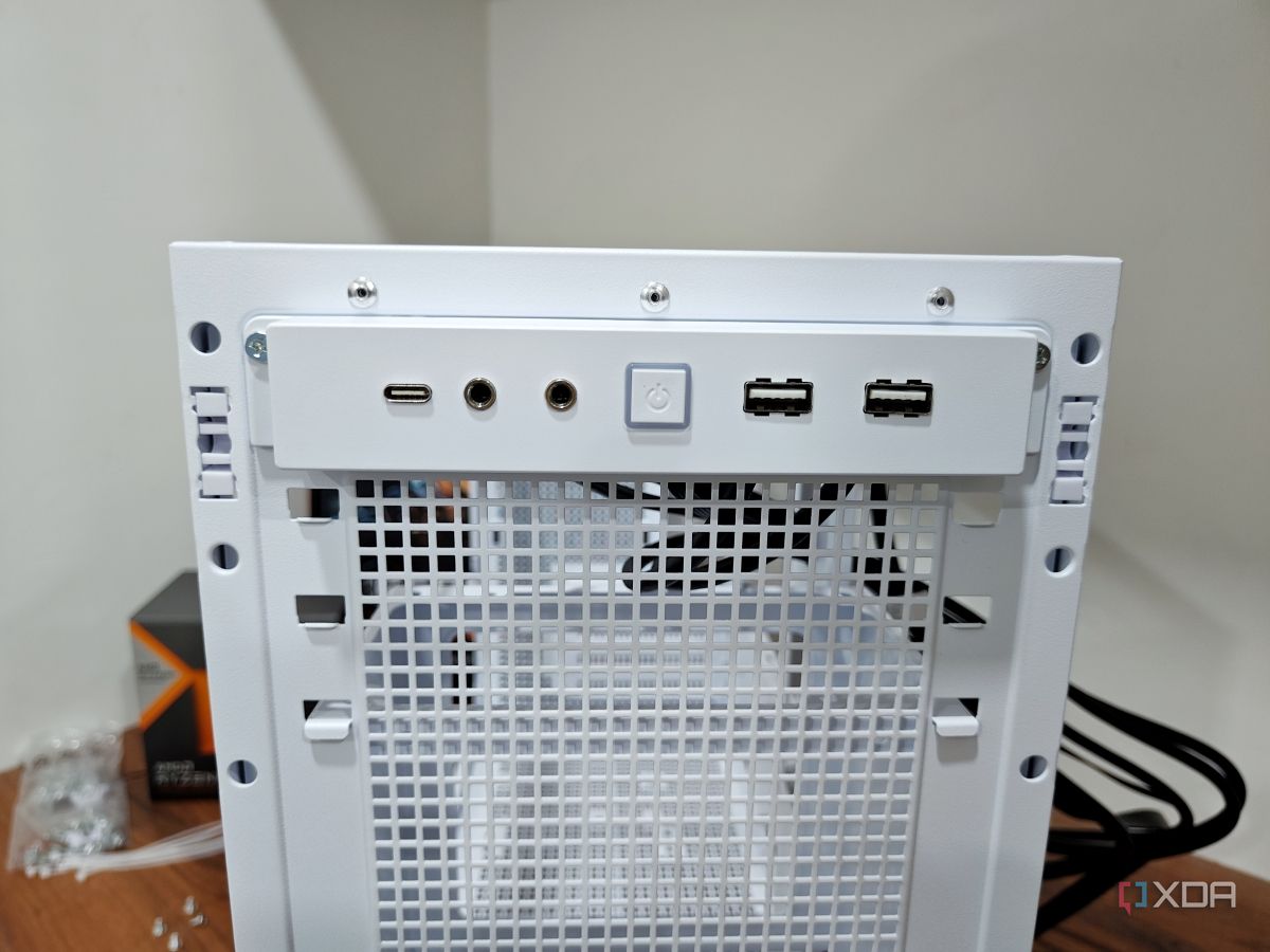 An image showing the front I/O panel of a white-colored Asus Prime AP201 case.