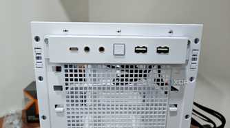 An image showing the front I/O panel of a white-colored Asus Prime AP201 case.