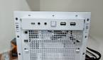 An image showing the front I/O panel of a white-colored Asus Prime AP201 case.