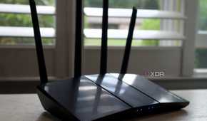 Asus RT-AX57 in front of a window with light reflections