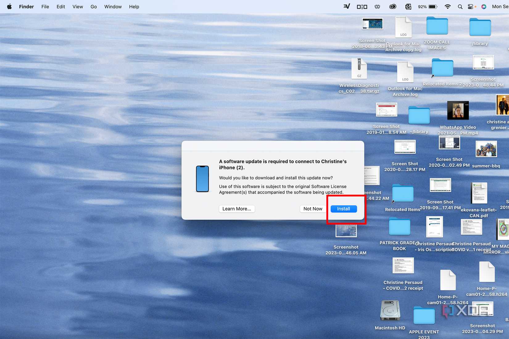 A MacBook showing a software update is needed to connect an iPhone with Install selected.