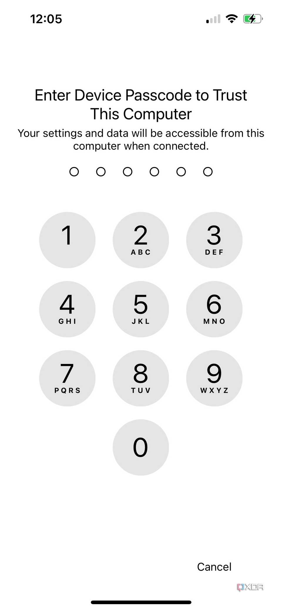 An iPhone screen with a numeric keypad asking you to enter your device passcode to trust a connected computer.
