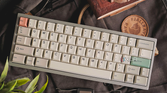 An image showing a custom mechanical keyboard with JTK keycaps on a bagpack.