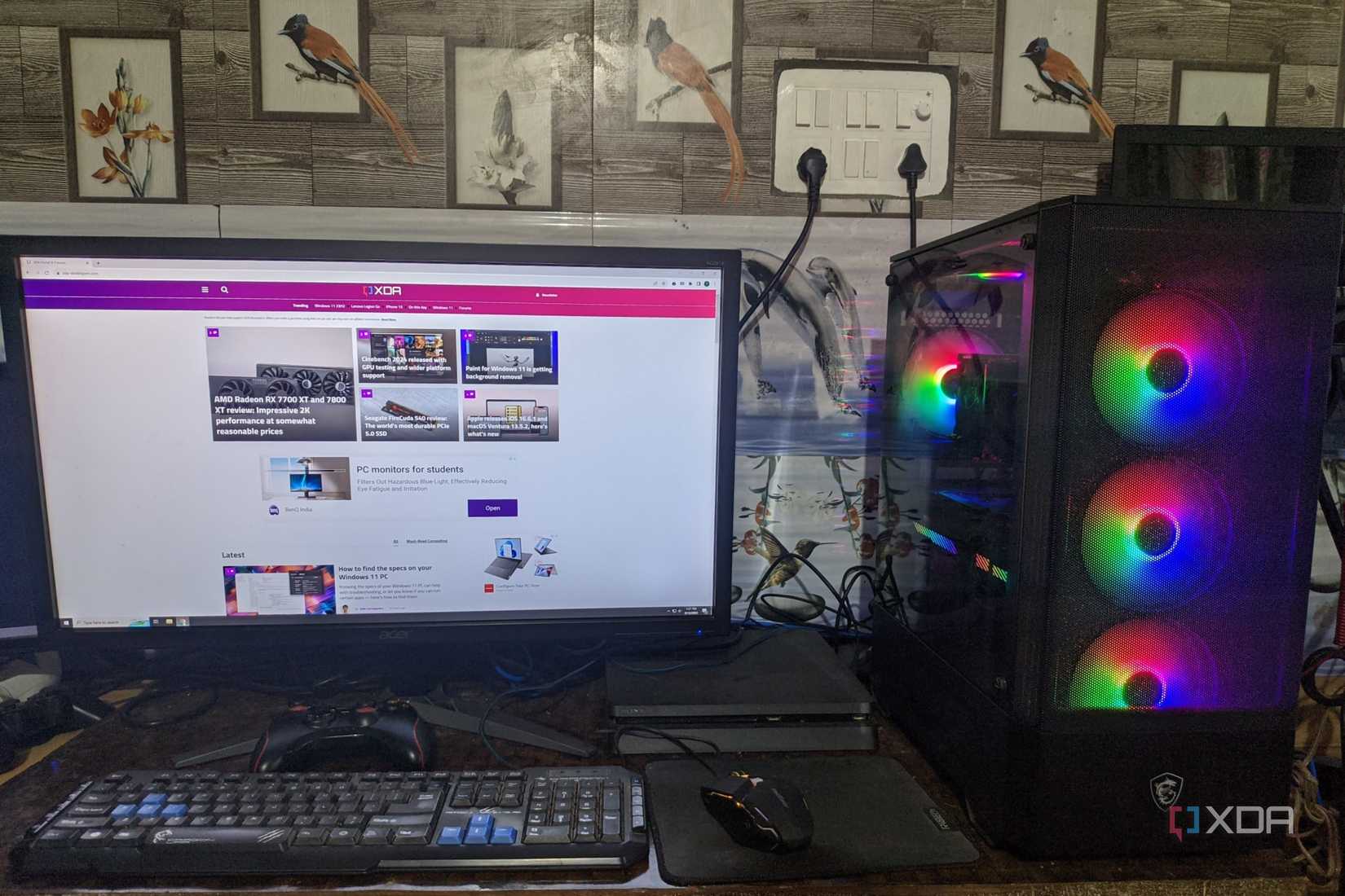 An image of a desktop PC with XDA open on the monitor and a PS4 Slim in the background