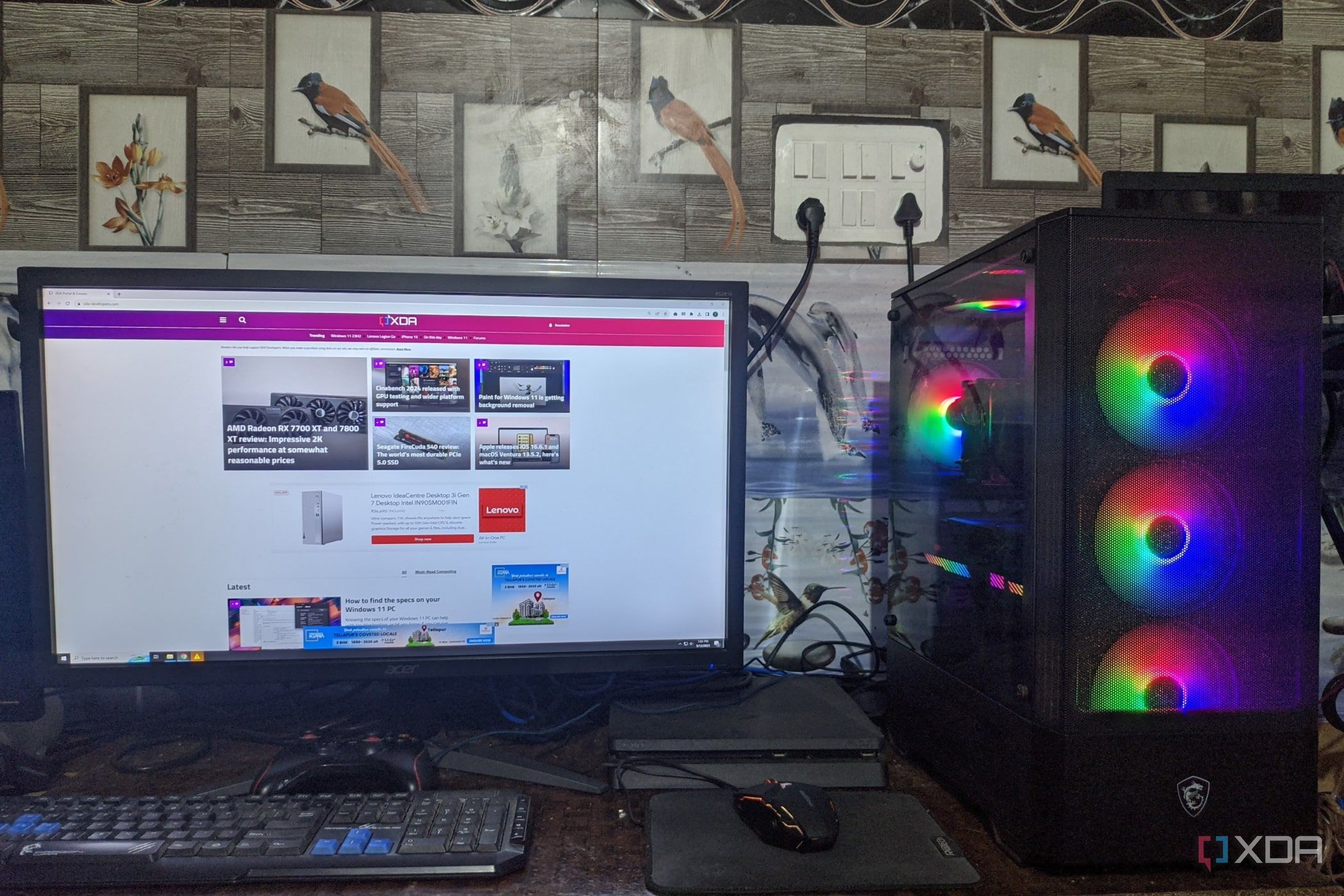 An image of a desktop PC with XDA open on the monitor and a PS4 in the background
