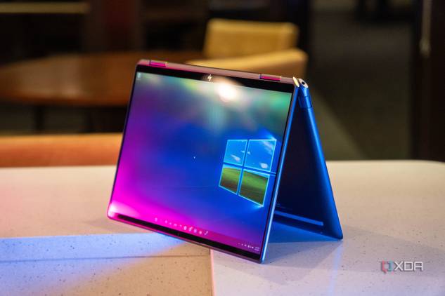 Convertible laptop on white counter with pink and blue lighting