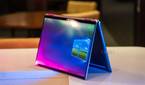 Convertible laptop on white counter with pink and blue lighting