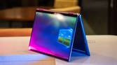 Convertible laptop on white counter with pink and blue lighting