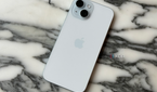 The back of an iPhone 15 on a marble tabletop.
