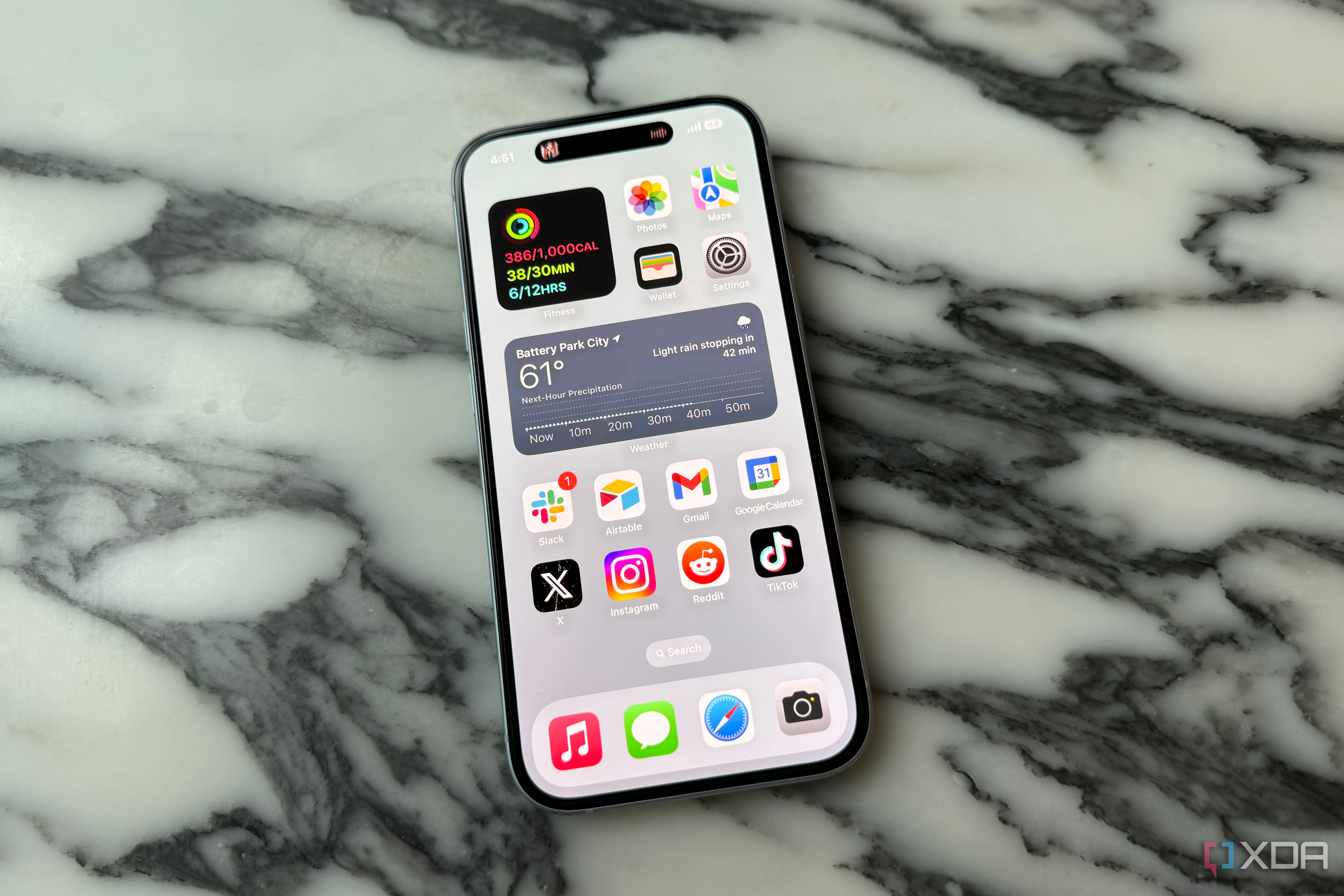 The iPhone 15's display on a marble tabletop.
