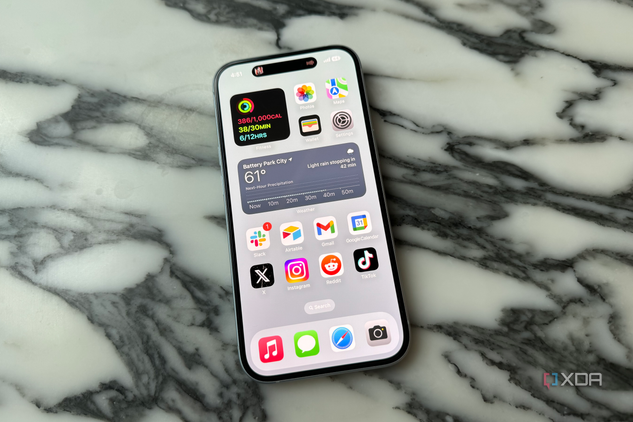 The iPhone 15's display on a marble tabletop.