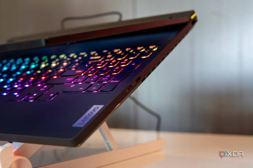 Close-up view of the right side of the Lenovo Legion 9i showing ports, a cooling exhaust, and the RGB backlit keyboard