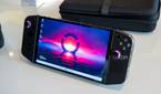 Angled front view of the Lenovo Legion Go handheld with showing a desktop background with pink and blue colors