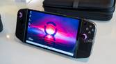 Angled front view of the Lenovo Legion Go handheld with showing a desktop background with pink and blue colors