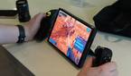 A Lenovo Legion Go with the controllers detached and the right controller being used in mouse mode