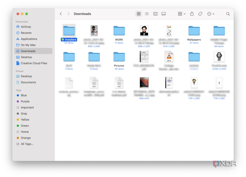 Finder on macOS showing downloads folder with a wide variety of files
