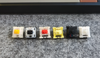 An image showing a bunch of MX-style mechanical switches on a deskmat.