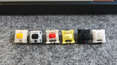 An image showing a bunch of MX-style mechanical switches on a deskmat.
