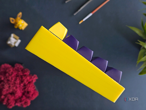 An image showing the side profile of a mechanical keyboard with a yellow case and MT3 Cyber keycaps.