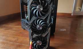 A screwdriver resting on an RTX 3080 Ti, with an MSI MAG Forge 110R in the background.