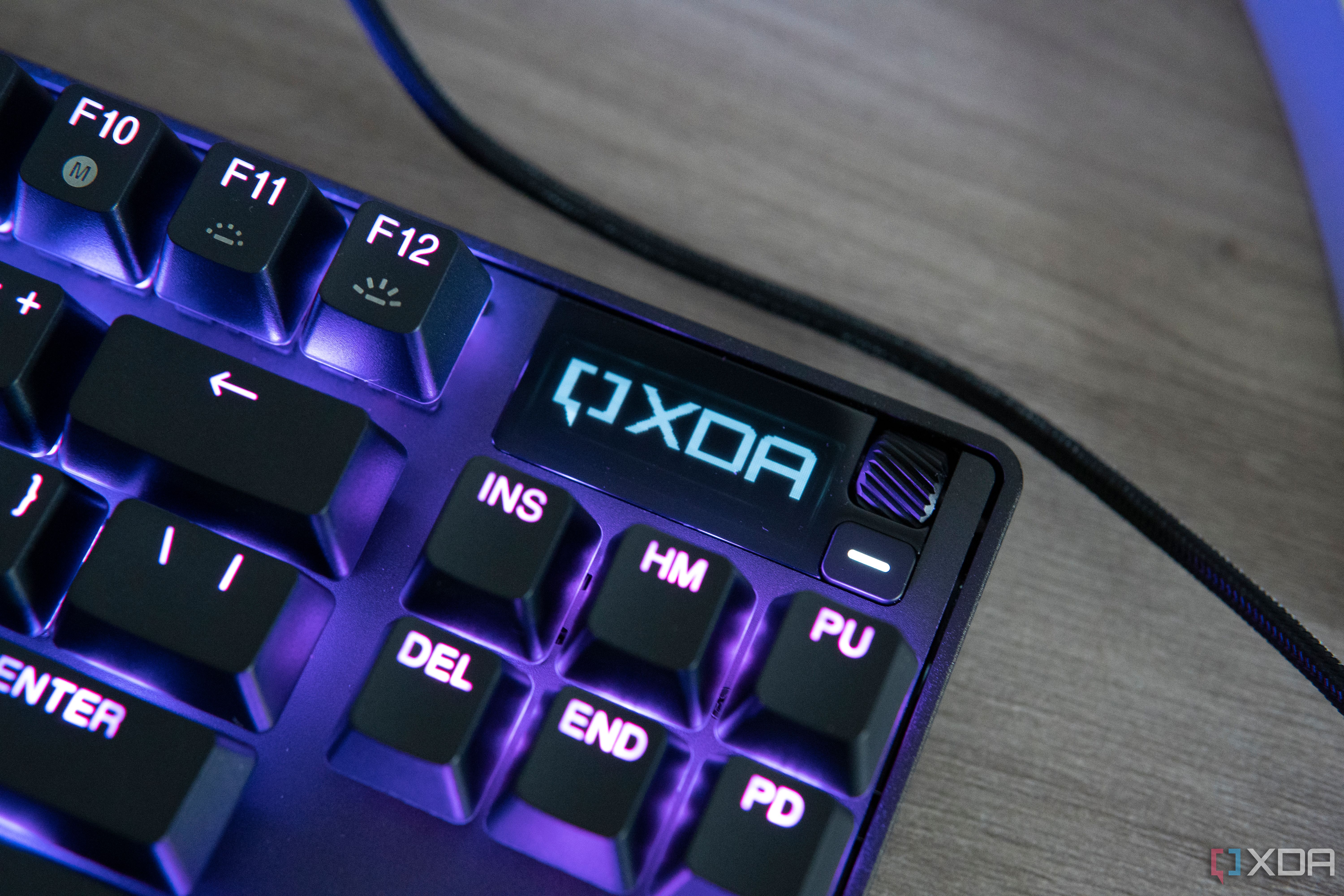 Close-up view of the OLED screen on the SteelSeries Apex Pro TKL displaying the XDA logo